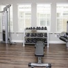 fitness room with equipment and on wood-style flooring